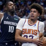 Phoenix Suns forward Cameron Johnson, right, drives to the basket against Dallas Mavericks forward Dorian Finney-Smith (10) during the first half of Game 6 of an NBA basketball second-round playoff series, Thursday, May 12, 2022, in Dallas. (AP Photo/Tony Gutierrez)