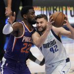 Dallas Mavericks forward Maxi Kleber (42) drives to the basket against Phoenix Suns center Deandre Ayton (22) during the second half of Game 3 of an NBA basketball second-round playoff series, Friday, May 6, 2022, in Dallas. (AP Photo/Tony Gutierrez)