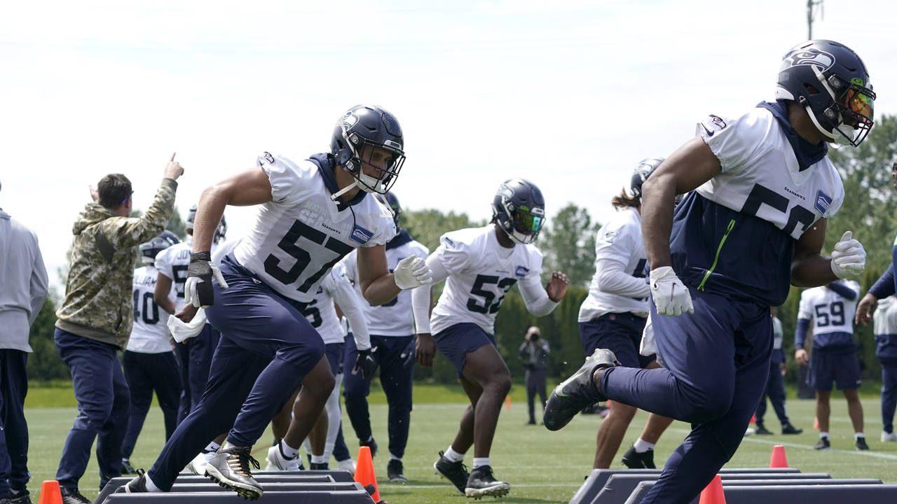 Seattle Seahawks linebackers Cody Barton (57) and Jordan Brooks, right, run a drill during NFL foot...
