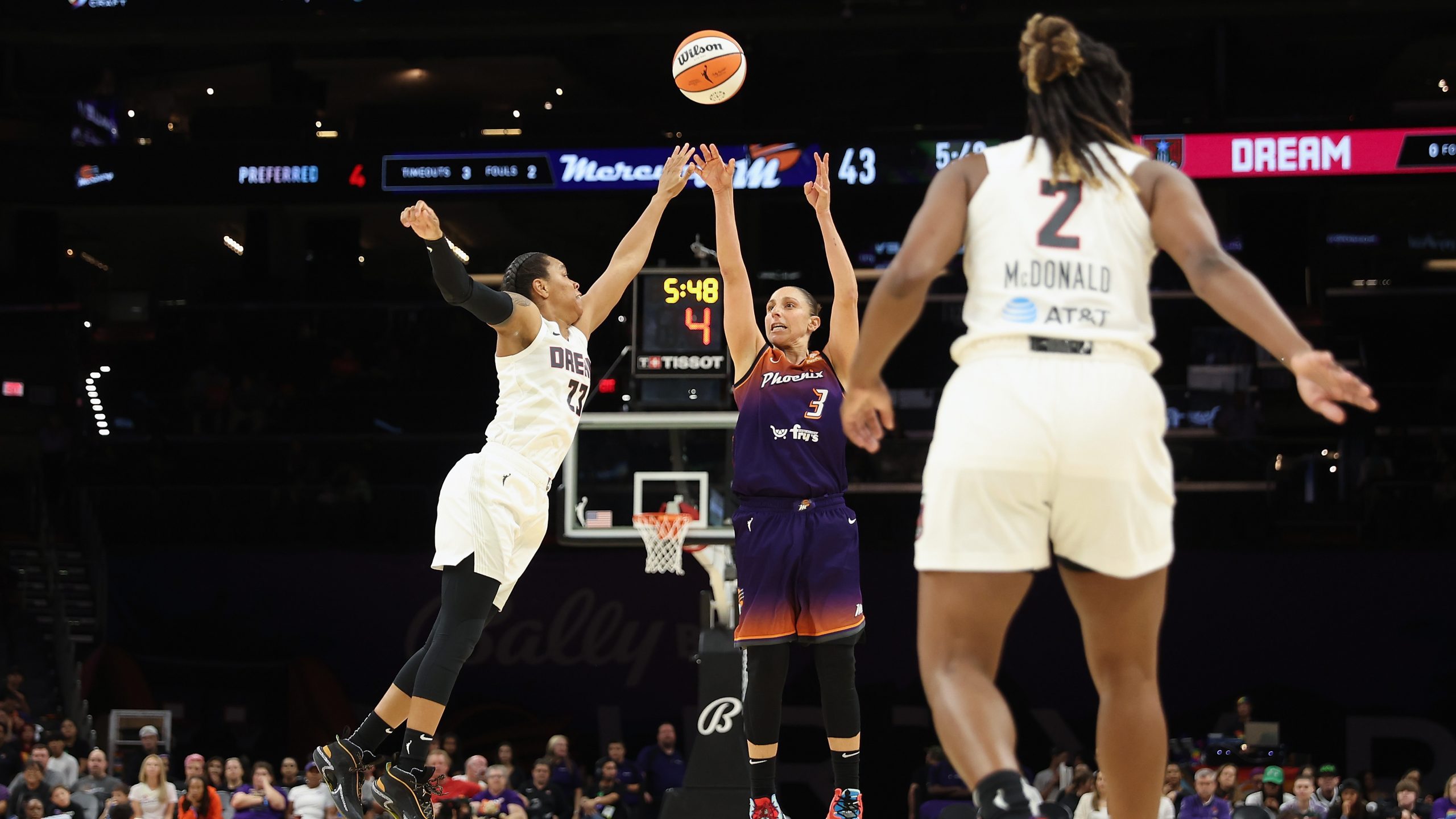 Diana Taurasi #3 of the Phoenix Mercury puts up a three-point shot over Asia Durr #23 of the Atlant...