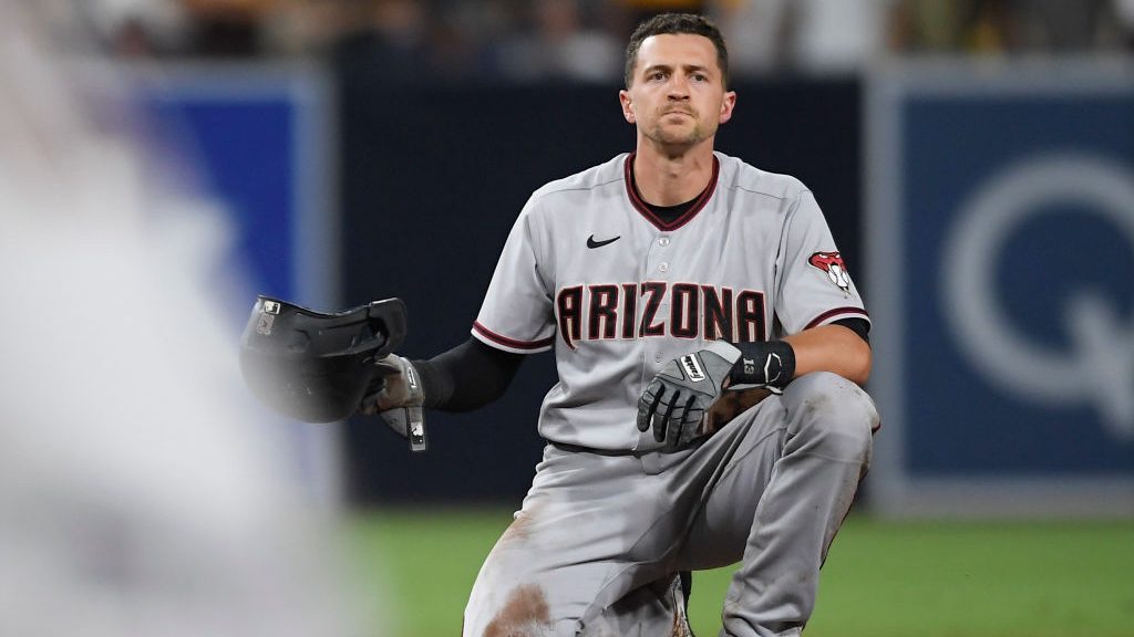 Nick Ahmed #13 of the Arizona Diamondbacks sits on second base after being tagged out during the fi...
