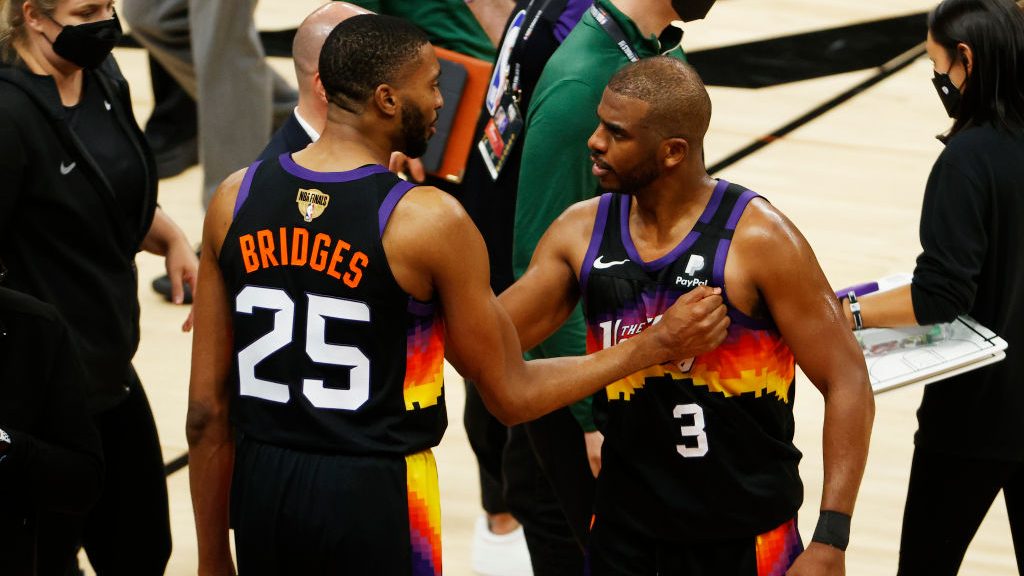Devin Booker #1 and Mikal Bridges #25 of the Phoenix Suns celebrates against the Milwaukee Bucks du...