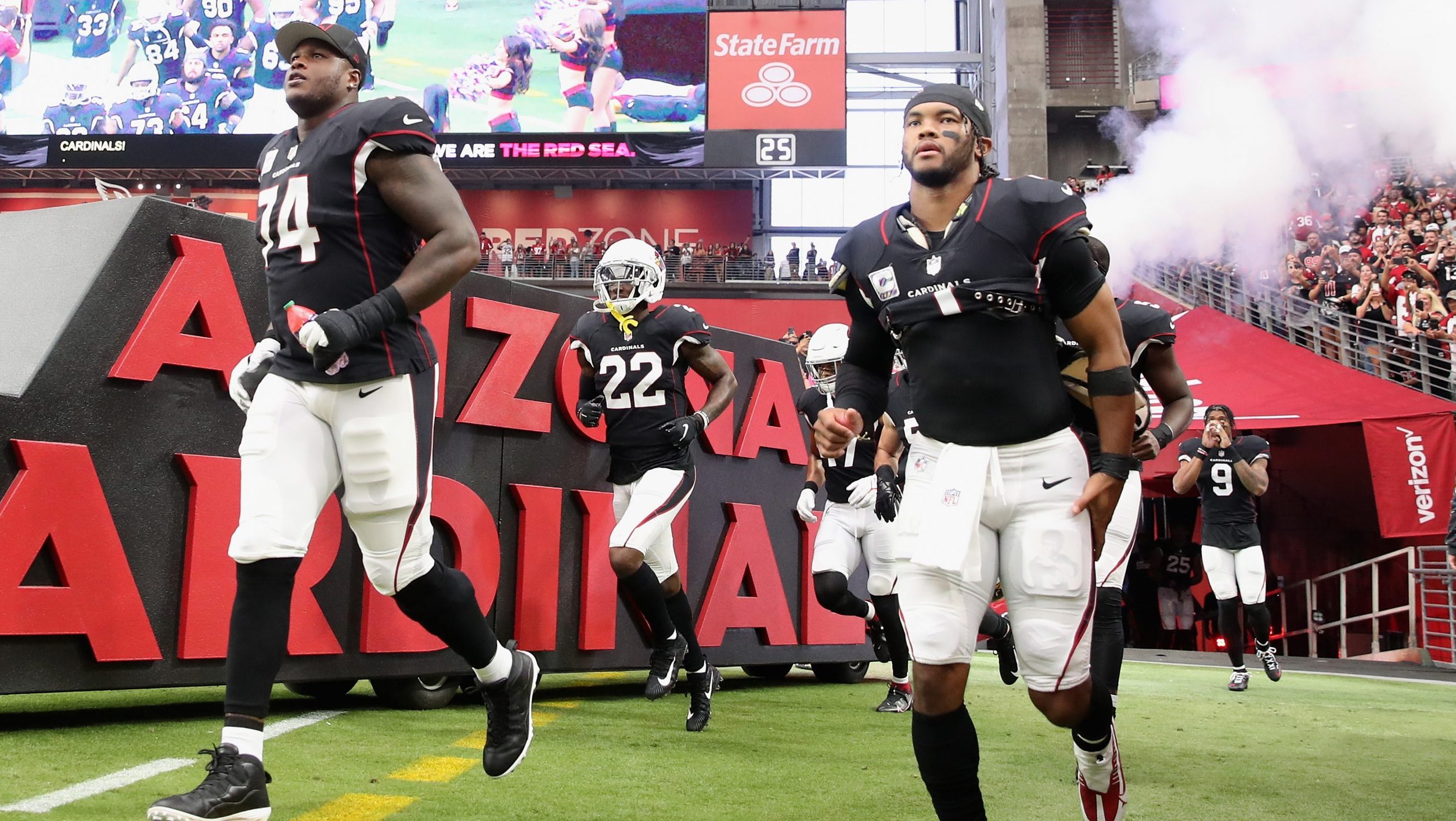 (L-R) D.J. Humphries #74 and Kyler Murray #1 of the Arizona Cardinals run onto the field before the...