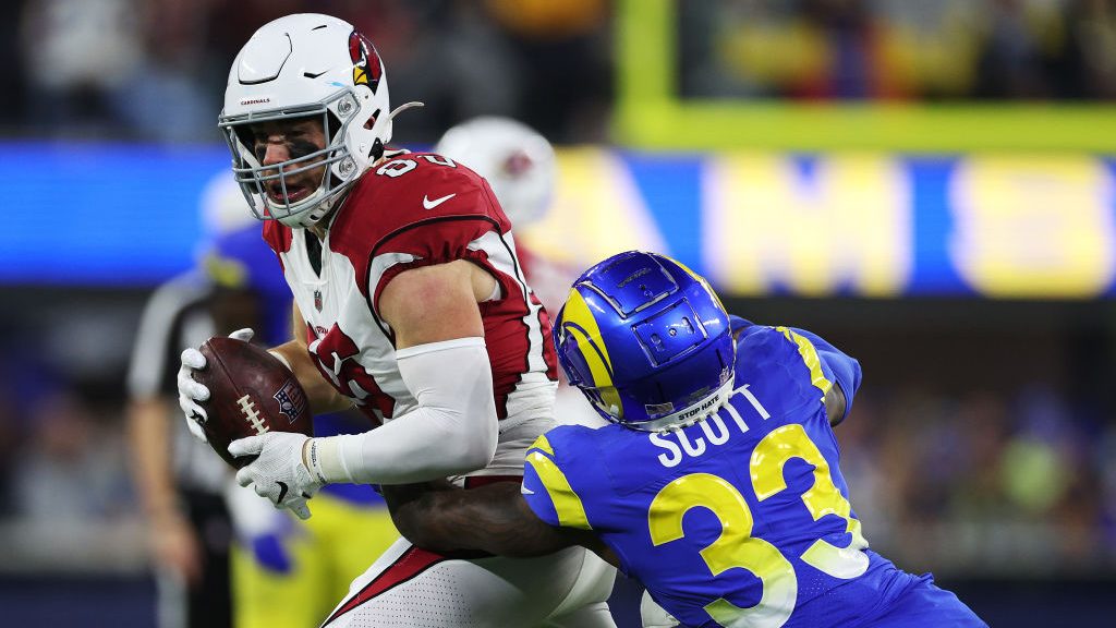 Nick Scott #33 of the Los Angeles Rams tackles Zach Ertz #86 of the Arizona Cardinals after a recep...