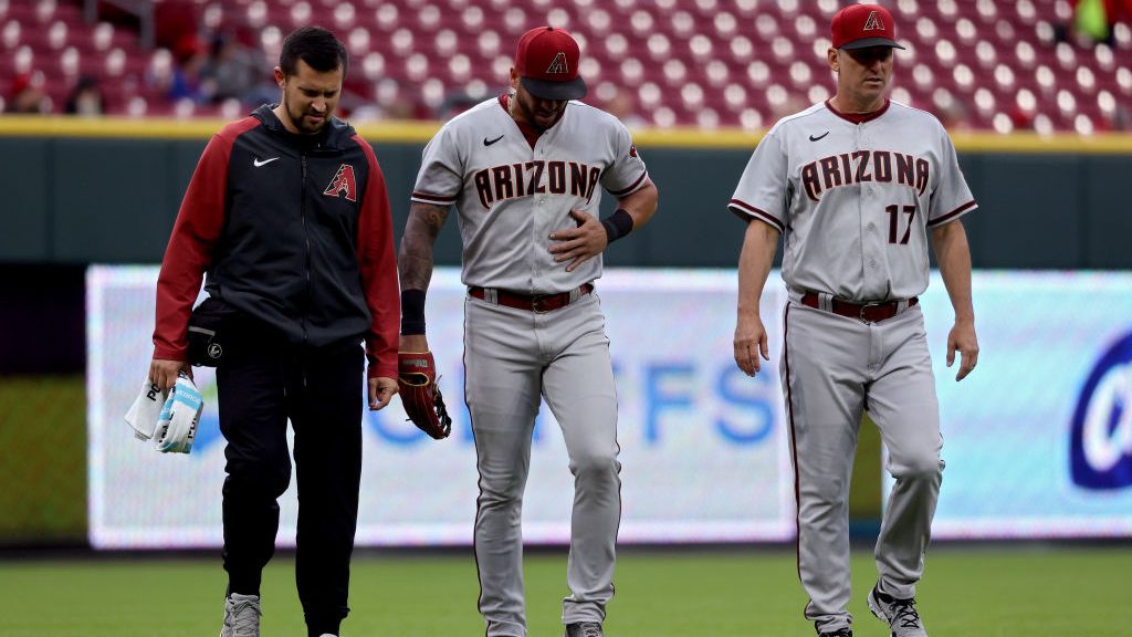 David Peralta #6 of the Arizona Diamondbacks leaves the field after being injured making a catch in...