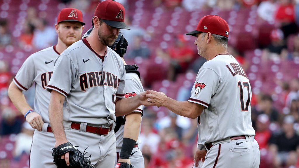 Manager Torey Lovullo of the Arizona Diamondbacks relieves Tyler Gilbert #49 in the second inning a...