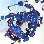 Colorado Avalanche left wing Gabriel Landeskog (92) celebrates a goal against the Tampa Bay Lightning with Bowen Byram (4) and Mikko Rantanen (96) during the first period of Game 1 of the NHL hockey Stanley Cup Final on Wednesday, June 15, 2022, in Denver. (AP Photo/John Locher)