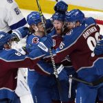 Colorado Avalanche left wing Gabriel Landeskog, second from right, is hugged by teammates after scoring against the Tampa Bay Lightning during the first period of Game 1 of the NHL hockey Stanley Cup Final on Wednesday, June 15, 2022, in Denver. (AP Photo/David Zalubowski)