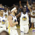 Golden State Warriors guard Klay Thompson, middle, reacts after scoring against the Boston Celtics during the second half of Game 5 of basketball's NBA Finals in San Francisco, Monday, June 13, 2022. (AP Photo/Jed Jacobsohn)