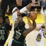 Boston Celtics guard Jaylen Brown (7) is defended by Golden State Warriors center Kevon Looney, top, during the second half of Game 5 of basketball's NBA Finals in San Francisco, Monday, June 13, 2022. (AP Photo/John Hefti)