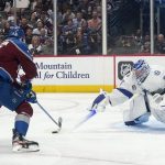 Tampa Bay Lightning goaltender Andrei Vasilevskiy (88) blocks a shot by Colorado Avalanche right wing Valeri Nichushkin (13) during the third period of Game 1 of the NHL hockey Stanley Cup Final on Wednesday, June 15, 2022, in Denver. (AP Photo/John Locher)