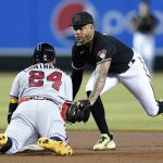 Atlanta Braves' William Contreras (24) slides safely into second base with a run-scoring double as Arizona Diamondbacks second baseman Ketel Marte, right, applies a late tag during the first inning of a baseball game Wednesday, June 1, 2022, in Phoenix. (AP Photo/Ross D. Franklin)