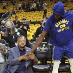 The Rev. Jesse Jackson, left, shakes hands with Golden State Warriors forward Draymond Green before Game 5 of basketball's NBA Finals between the Warriors and the Boston Celtics in San Francisco, Monday, June 13, 2022. (AP Photo/Jed Jacobsohn)