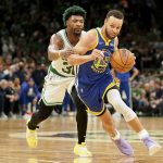 Golden State Warriors guard Stephen Curry (30) drives against Boston Celtics guard Marcus Smart (36) during the fourth quarter of Game 6 of basketball's NBA Finals, Thursday, June 16, 2022, in Boston. (AP Photo/Steven Senne)