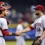 Cincinnati Reds relief pitcher Hunter Strickland (54) shakes hands with Reds catcher Aramis Garcia, left, after the final out in the ninth inning of a baseball game against the Arizona Diamondbacks Monday, June 13, 2022, in Phoenix. The Reds won 5-4. (AP Photo/Ross D. Franklin)