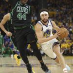 Golden State Warriors guard Klay Thompson (11) drives to the basket against Boston Celtics center Robert Williams III (44) during the second half of Game 5 of basketball's NBA Finals in San Francisco, Monday, June 13, 2022. (AP Photo/Jed Jacobsohn)