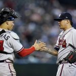 Atlanta Braves relief pitcher Jesse Chavez, right, slaps hands with catcher William Contreras after the team's baseball game against the Arizona Diamondbacks on Wednesday, June 1, 2022, in Phoenix. The Braves won 6-0. (AP Photo/Ross D. Franklin)