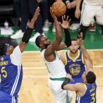 Boston Celtics guard Jaylen Brown (7) puts up a shot against Golden State Warriors center Kevon Looney (5) and guard Jordan Poole (3) during the third quarter of Game 6 of basketball's NBA Finals, Thursday, June 16, 2022, in Boston. (AP Photo/Michael Dwyer)