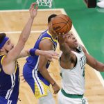Boston Celtics center Al Horford (42) puts up a shot against Golden State Warriors guard Klay Thompson (11) during the fourth quarter of Game 6 of basketball's NBA Finals, Thursday, June 16, 2022, in Boston. (AP Photo/Michael Dwyer)