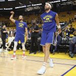 Golden State Warriors guards Stephen Curry, left, and Klay Thompson warm up before Game 5 of basketball's NBA Finals against the Boston Celtics in San Francisco, Monday, June 13, 2022. (AP Photo/Jed Jacobsohn)