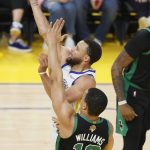 Golden State Warriors guard Stephen Curry, top, shoots against Boston Celtics forward Grant Williams (12) during the first half of Game 5 of basketball's NBA Finals in San Francisco, Monday, June 13, 2022. (AP Photo/John Hefti)