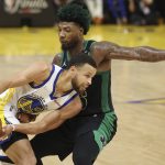 Golden State Warriors guard Stephen Curry, left, is defended by Boston Celtics guard Marcus Smart during the first half of Game 5 of basketball's NBA Finals in San Francisco, Monday, June 13, 2022. (AP Photo/Jed Jacobsohn)