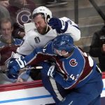 Tampa Bay Lightning left wing Alex Killorn, top, is pressed against the boards by Colorado Avalanche defenseman Josh Manson (42) during the second period of Game 1 of the NHL hockey Stanley Cup Final on Wednesday, June 15, 2022, in Denver. (AP Photo/David Zalubowski)