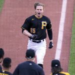 Pittsburgh Pirates' Jack Suwinski (65) is greeted by teammates as he crosses home plate after hitting a two-run walk-off home run off Arizona Diamondbacks relief pitcher Mark Melancon during the ninth inning of a baseball game in Pittsburgh, Saturday, June 4, 2022. The Pirates won 2-1. (AP Photo/Gene J. Puskar)