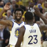 Golden State Warriors forward Andrew Wiggins, left, celebrates with forward Draymond Green (23) during the first half of Game 5 of basketball's NBA Finals against the Boston Celtics in San Francisco, Monday, June 13, 2022. (AP Photo/Jed Jacobsohn)