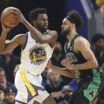 Golden State Warriors forward Andrew Wiggins (22) drives to the basket against Boston Celtics guard Derrick White during the first half of Game 5 of basketball's NBA Finals in San Francisco, Monday, June 13, 2022. (AP Photo/Jed Jacobsohn)