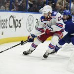 New York Rangers defenseman Adam Fox (23) beats Tampa Bay Lightning center Anthony Cirelli (71) to a loose puck during the second period in Game 6 of the NHL hockey Stanley Cup playoffs Eastern Conference finals, Saturday, June 11, 2022, in Tampa, Fla. (AP Photo/Chris O'Meara)
