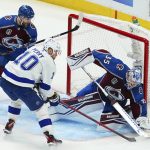 Colorado Avalanche goaltender Darcy Kuemper (35) blocks a shot by Tampa Bay Lightning right wing Corey Perry (10) during the second period of Game 1 of the NHL hockey Stanley Cup Final on Wednesday, June 15, 2022, in Denver. (AP Photo/John Locher)