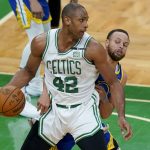 Boston Celtics center Al Horford (42) looks to drive against Golden State Warriors guard Stephen Curry (30) during the third quarter of Game 6 of basketball's NBA Finals, Thursday, June 16, 2022, in Boston. (AP Photo/Steven Senne)