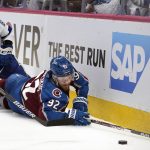 Colorado Avalanche left wing Gabriel Landeskog (92) reaches for the puck in front of Tampa Bay Lightning defenseman Erik Cernak (81) during the second period of Game 1 of the NHL hockey Stanley Cup Final Wednesday, June 15, 2022, in Denver. (AP Photo/John Locher)