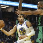 Golden State Warriors forward Otto Porter Jr. (32) passes the ball against Boston Celtics center Robert Williams III, rear, and center Al Horford during the second half of Game 5 of basketball's NBA Finals in San Francisco, Monday, June 13, 2022. (AP Photo/Jed Jacobsohn)