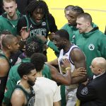 Golden State Warriors forward Draymond Green, middle, talks with an official between Boston Celtics players during the second half of Game 5 of basketball's NBA Finals in San Francisco, Monday, June 13, 2022. (AP Photo/John Hefti)