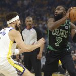 Boston Celtics guard Jaylen Brown (7) is defended by Golden State Warriors guard Klay Thompson during the first half of Game 5 of basketball's NBA Finals in San Francisco, Monday, June 13, 2022. (AP Photo/Jed Jacobsohn)