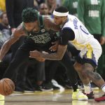 Boston Celtics guard Marcus Smart, left, is defended by Golden State Warriors guard Gary Payton II during the second half of Game 5 of basketball's NBA Finals in San Francisco, Monday, June 13, 2022. (AP Photo/Jed Jacobsohn)