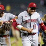 Cincinnati Reds first baseman Joey Votto (19) and Reds shortstop Kyle Farmer, left, laugh as they run off the field after a baseball game against the Arizona Diamondbacks Monday, June 13, 2022, in Phoenix. The Reds won 5-4. (AP Photo/Ross D. Franklin)