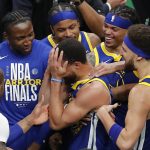 Golden State Warriors guard Stephen Curry, center, celebrates with teammates after beating the Boston Celtics in Game 6 to win basketball's NBA Finals championship, Thursday, June 16, 2022, in Boston. (AP Photo/Michael Dwyer)