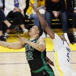 Boston Celtics forward Grant Williams (12) shoots against Golden State Warriors center Kevon Looney during the second half of Game 5 of basketball's NBA Finals in San Francisco, Monday, June 13, 2022. (AP Photo/John Hefti)