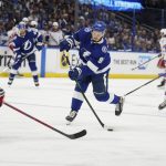 Tampa Bay Lightning defenseman Mikhail Sergachev (98) shooys against New York Rangers defenseman Jacob Trouba (8) during the second period in Game 6 of the NHL hockey Stanley Cup playoffs Eastern Conference finals, Saturday, June 11, 2022, in Tampa, Fla. (AP Photo/Chris O'Meara)