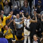 Golden State Warriors guard Jordan Poole (3) celebrates with fans after scoring against the Boston Celtics during the second half of Game 5 of basketball's NBA Finals in San Francisco, Monday, June 13, 2022. (AP Photo/John Hefti)