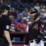Arizona Diamondbacks' Christian Walker, right, stares at umpire Alex Tosi after being called out on strikes during the third inning of a baseball game against the Atlanta Braves Wednesday, June 1, 2022, in Phoenix. (AP Photo/Ross D. Franklin)