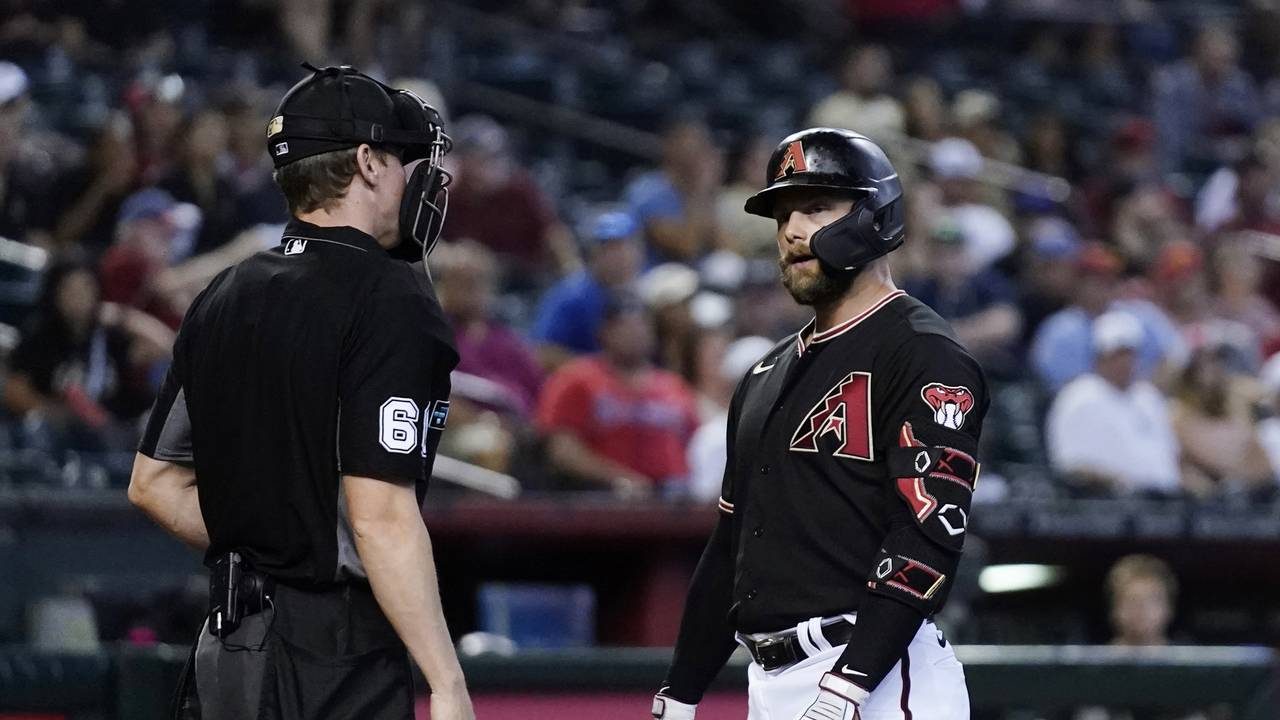 Arizona Diamondbacks' Christian Walker, right, stares at umpire Alex Tosi after being called out on...