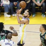 Golden State Warriors guard Stephen Curry, middle, shoots against the Boston Celtics during the first half of Game 5 of basketball's NBA Finals in San Francisco, Monday, June 13, 2022. (AP Photo/John Hefti)