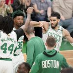 Boston Celtics forward Jayson Tatum (0) reacts with center Robert Williams III (44) during the first quarter of Game 6 of basketball's NBA Finals against the Golden State Warriors, Thursday, June 16, 2022, in Boston. (AP Photo/Steven Senne)