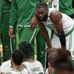 Boston Celtics guard Jaylen Brown (7) takes a break during a timeout during the third quarter of Game 6 of basketball's NBA Finals against the Golden State Warriors, Thursday, June 16, 2022, in Boston. (AP Photo/Steven Senne)