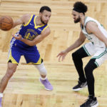 Golden State Warriors guard Stephen Curry (30) looks to drive against Boston Celtics guard Derrick White (9) during the first quarter of Game 6 of basketball's NBA Finals, Thursday, June 16, 2022, in Boston. (AP Photo/Michael Dwyer)