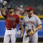 Arizona Diamondbacks' David Peralta (6) motions to his bench after hitting a double as Cincinnati Reds' Mike Moustakas (9) looks on during the second inning of a baseball game, Wednesday, June 15, 2022, in Phoenix. (AP Photo/Matt York)